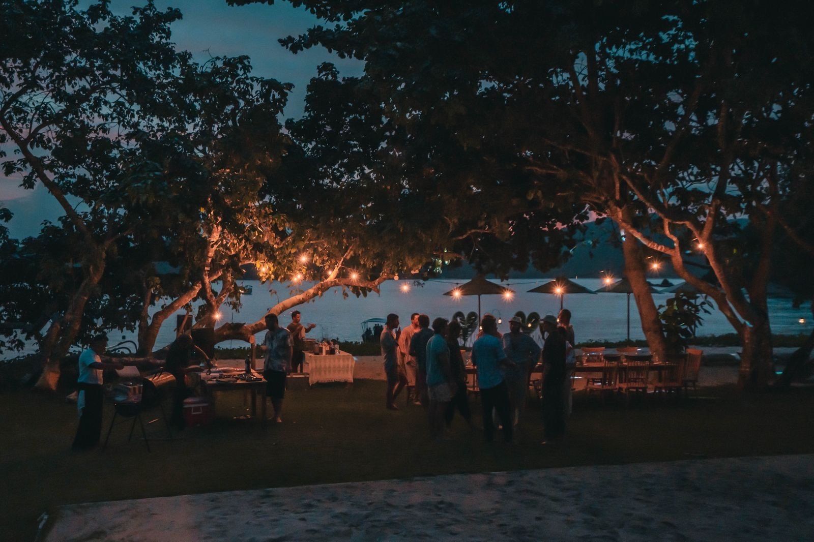 Dinner on the beach under lanterns