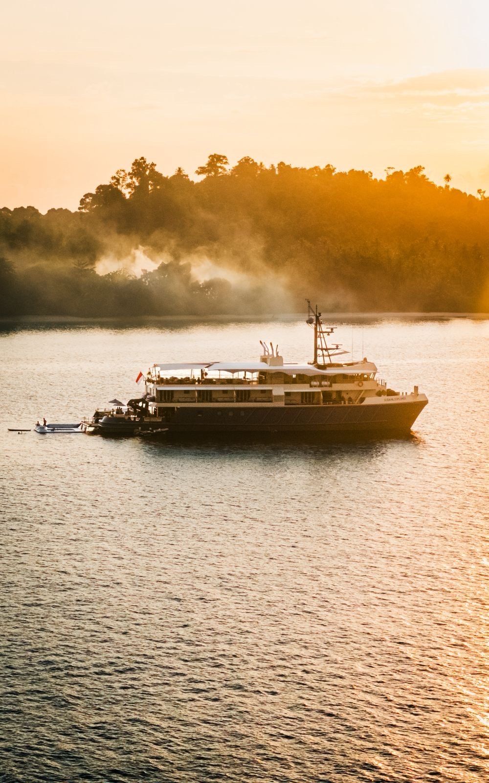 The boat at anchor in golden-hour haze