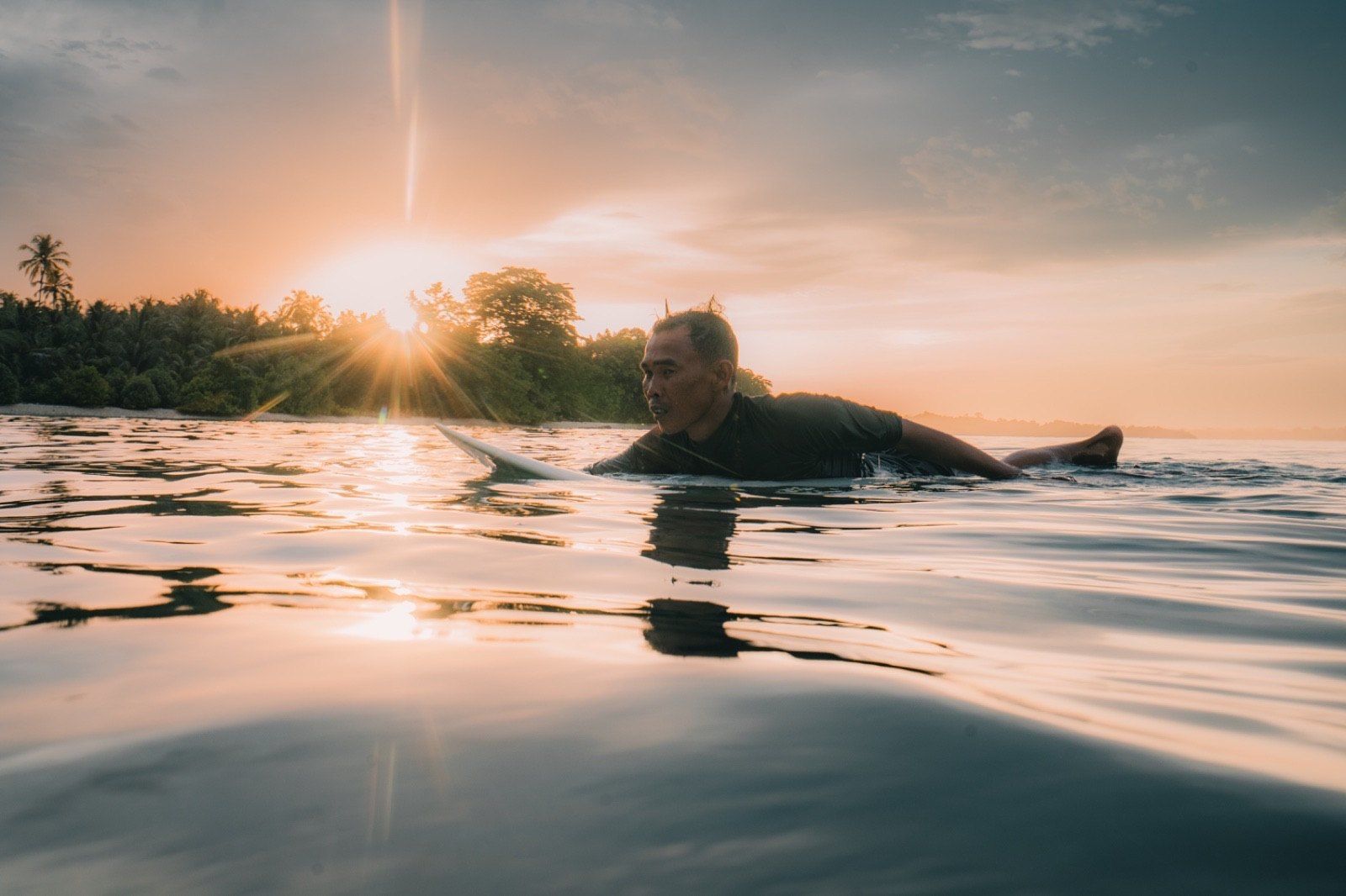 A swimmer at first light in clear shallow water